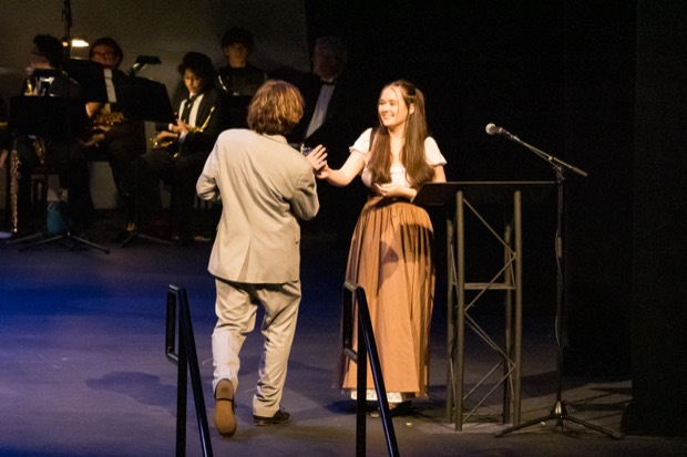 A student accepting an award