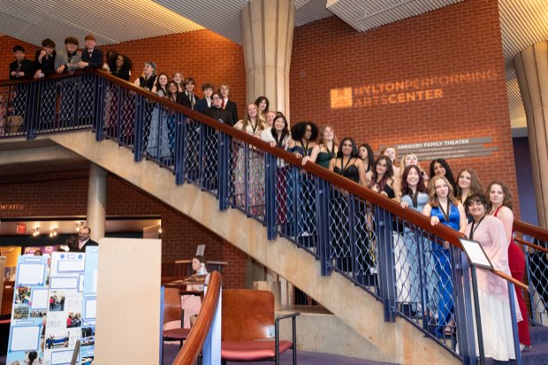 The full company gathers on the Hylton staircase