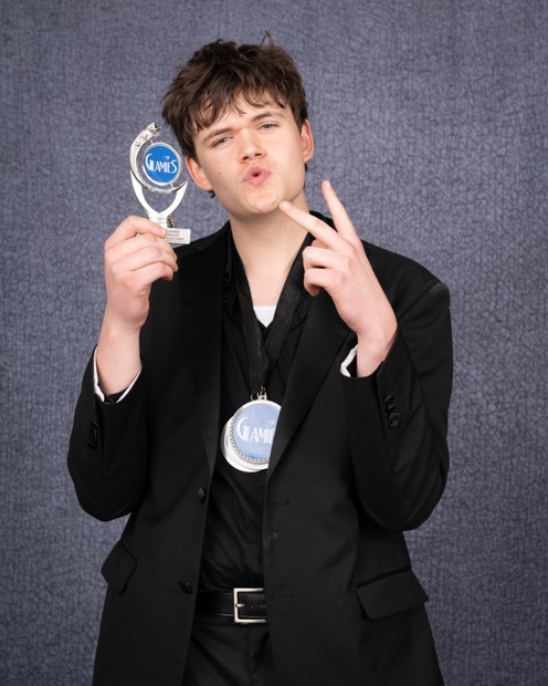 A Glamies honoree with their award