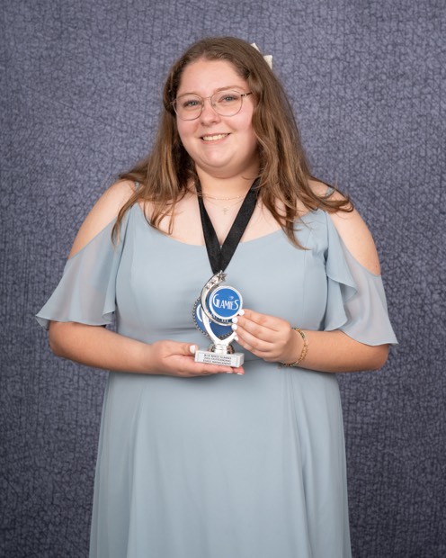 A Glamies honoree with their award