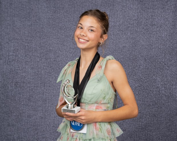 A Glamies honoree with their award