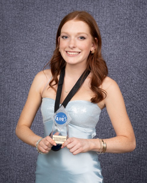 A Glamies honoree with their award