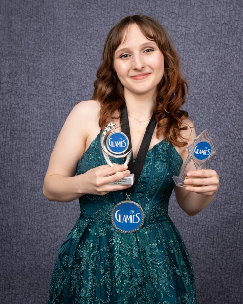 A Glamies honoree with their award
