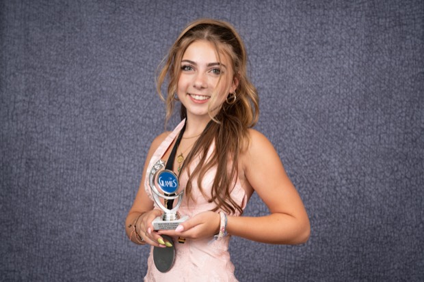 A Glamies honoree with their award