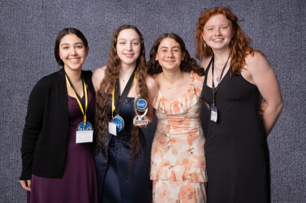 A Glamies honoree with their award