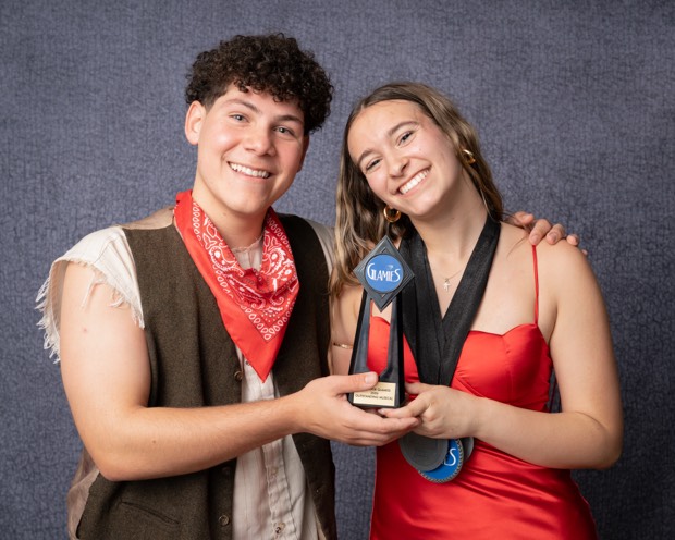 A Glamies honoree with their award